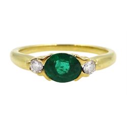 18ct gold oval emerald and diamond three stone ring, hallmarked