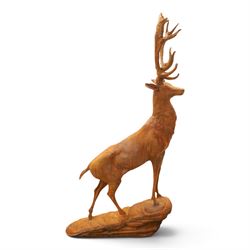 Pair of cast iron stags, upon a on moulded rocky plinth, standing alert 