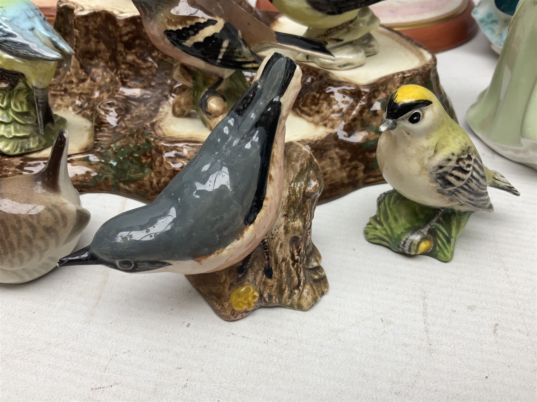 Nine Beswick bird figures, with stand, together with USSR thrush, two Franklin Mint Jane Austin figures and four Royal Doulton figures 