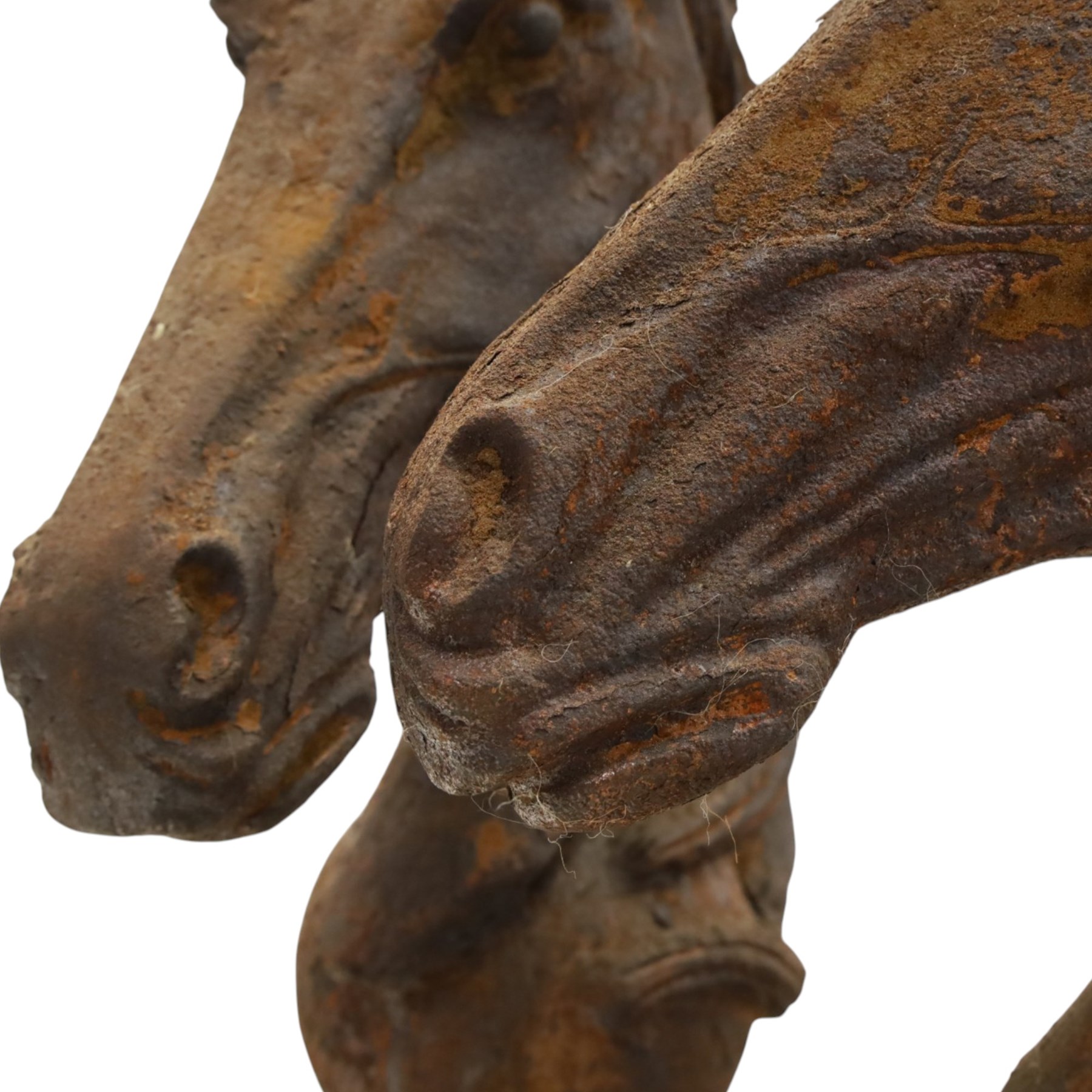 Pair of antique cast iron garden finials or statues of horse heads or busts, the heads with flowing and pierced mane, mounted on spherical finials over square tapering bases