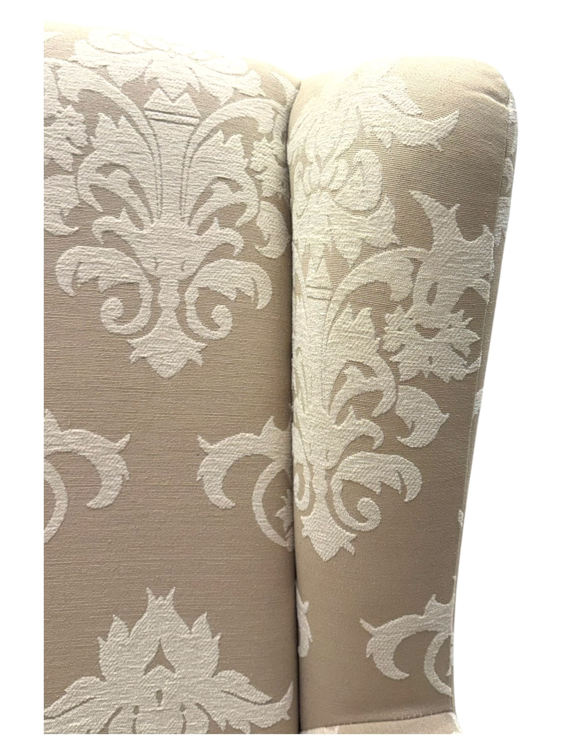 Chatsworth hardwood-framed armchair upholstered in cream  damask, with rolled arms and cushioned seat, raised on square tapered feet