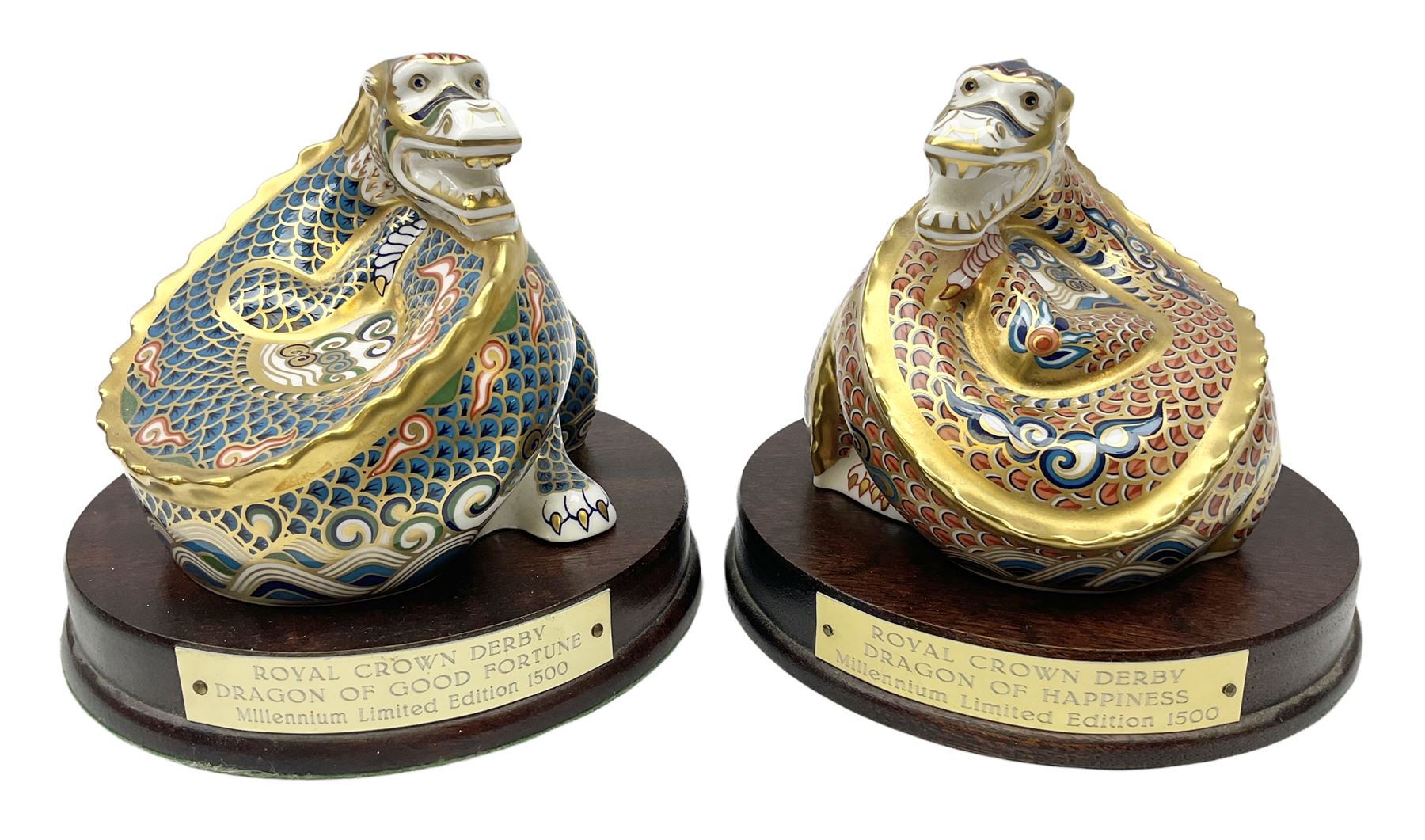 Two Royal Crown Derby paperweights, Dragon of Happiness, limited edition 1227/1500 and Dragon of Good Fortune, limited edition 1227/1500, both with gold stopper, hardwood base, certificate and with printed mark beneath