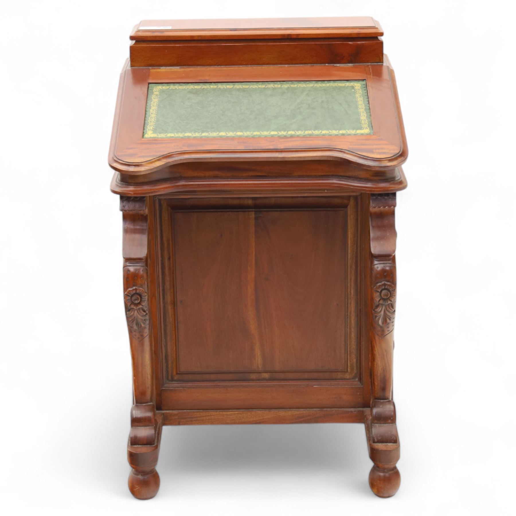 Victorian design mahogany Davenport desk, the sloped writing surface inset with tooled green leather and hinged to reveal a fitted interior, with a pen compartment to the raised gallery back, four drawers to each side, on carved scrolled supports with acanthus detail, raised on turned feet