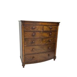 Victorian mahogany bow-front chest, fitted with two short and four long cock-beaded drawers, flanked by pilasters, raised on turned feet