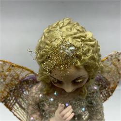 Anna Meszaros Hungary - hand made needlework figurine of an Angel with metallic lace full length dress and open threadwork wings; on moulded base H45cm Auctioneer's Note: Anna Meszaros came to England from her native Hungary in 1959 to marry an English businessman she met while demonstrating her art at the 1958 Brussels Exhibition. Shortly before she left for England she was awarded the title of Folk Artist Master by the Hungarian Government. Anna was a gifted painter of mainly portraits and sculptress before starting to make her figurines which are completely hand made and unique, each with a character and expression of its own. The hands, feet and face are sculptured by layering the material and pulling the features into place with needle and thread. She died in Hull in 1998.