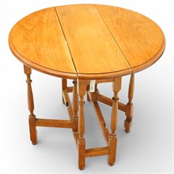 Late 20th century small oak gate leg side table, with circular drop-leaf top formed of three planks, raised on turned supports with gate legs and rectangular stretchers