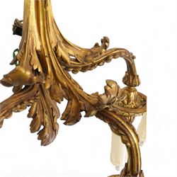 Pair of Lous XVI style ormolu three branch wall sconces, with scrolling foliate backplates and leaf-capped reeded scrolling branches, converted to electricity 