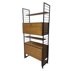 Staples Ladderax - mid-20th century teak and metal framed modular wall unit, fitted with central fall-front cupboard enclosing correspondence dividers, over secondary separate teak fall-front cupboard, adjustable shelf to top