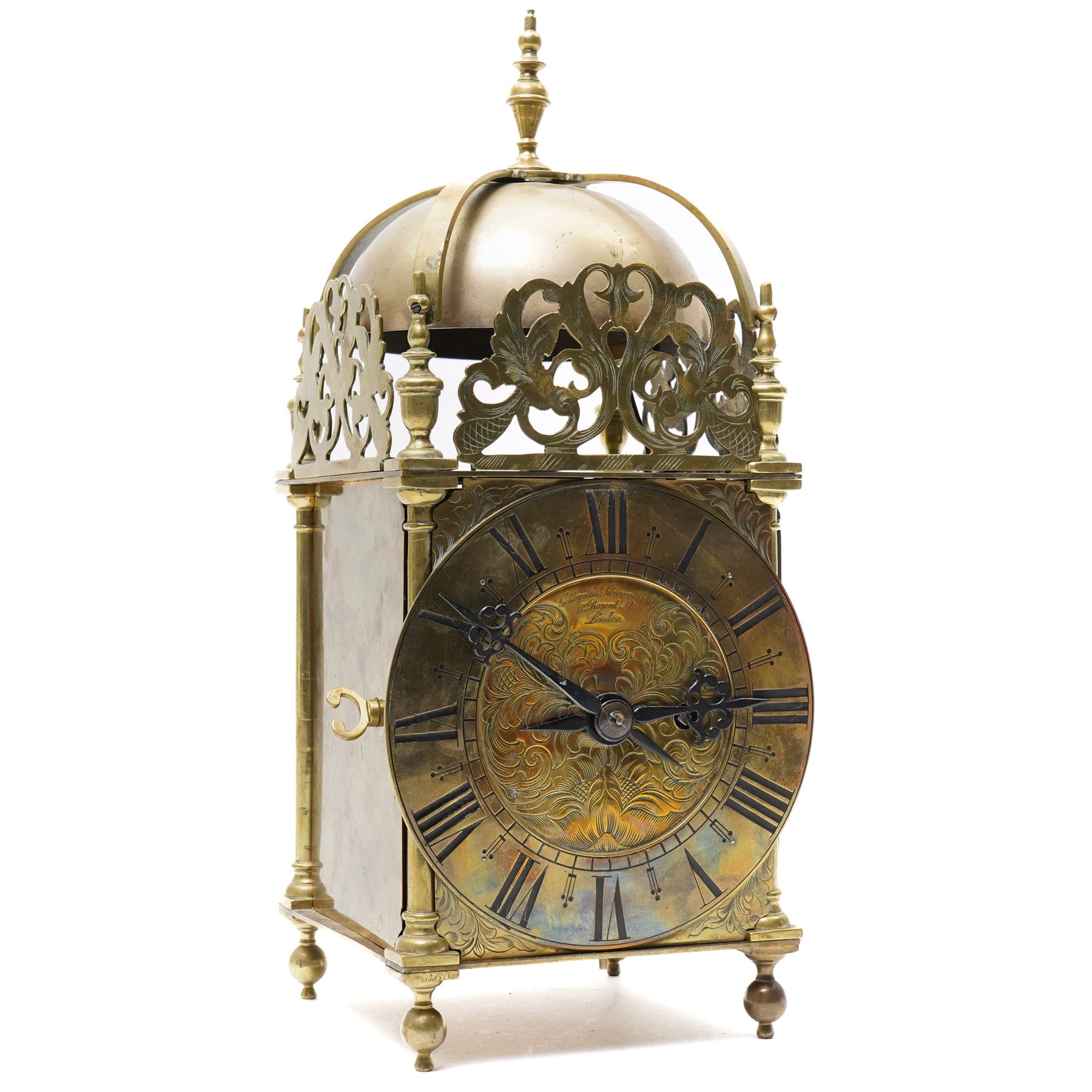 English-17th-century style replica 8-day lantern clock with a suspended bell and turned finials, with three ornate frets to the front and sides and opening side and rear doors, with an engraved dial centre and formerly silvered chapter with engraved Roman numerals, inner quarter hour track and period steel hands, dial engraved 