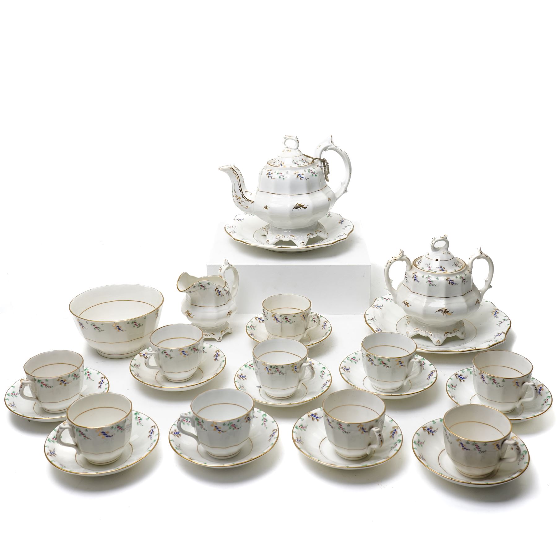 19th century English porcelain tea service, possibly Coalport, comprising teapot, covered sucrier, ten teacups and saucers, slop bowl, milk jug, and two serving dishes