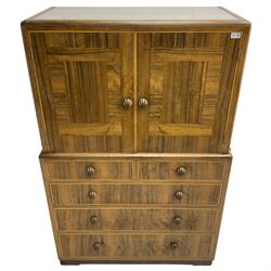 Early 20th century Art Deco walnut cocktail tallboy chest, fitted with double cupboard enclosing two shelves over two short and three long drawers, each with shell shaped handes