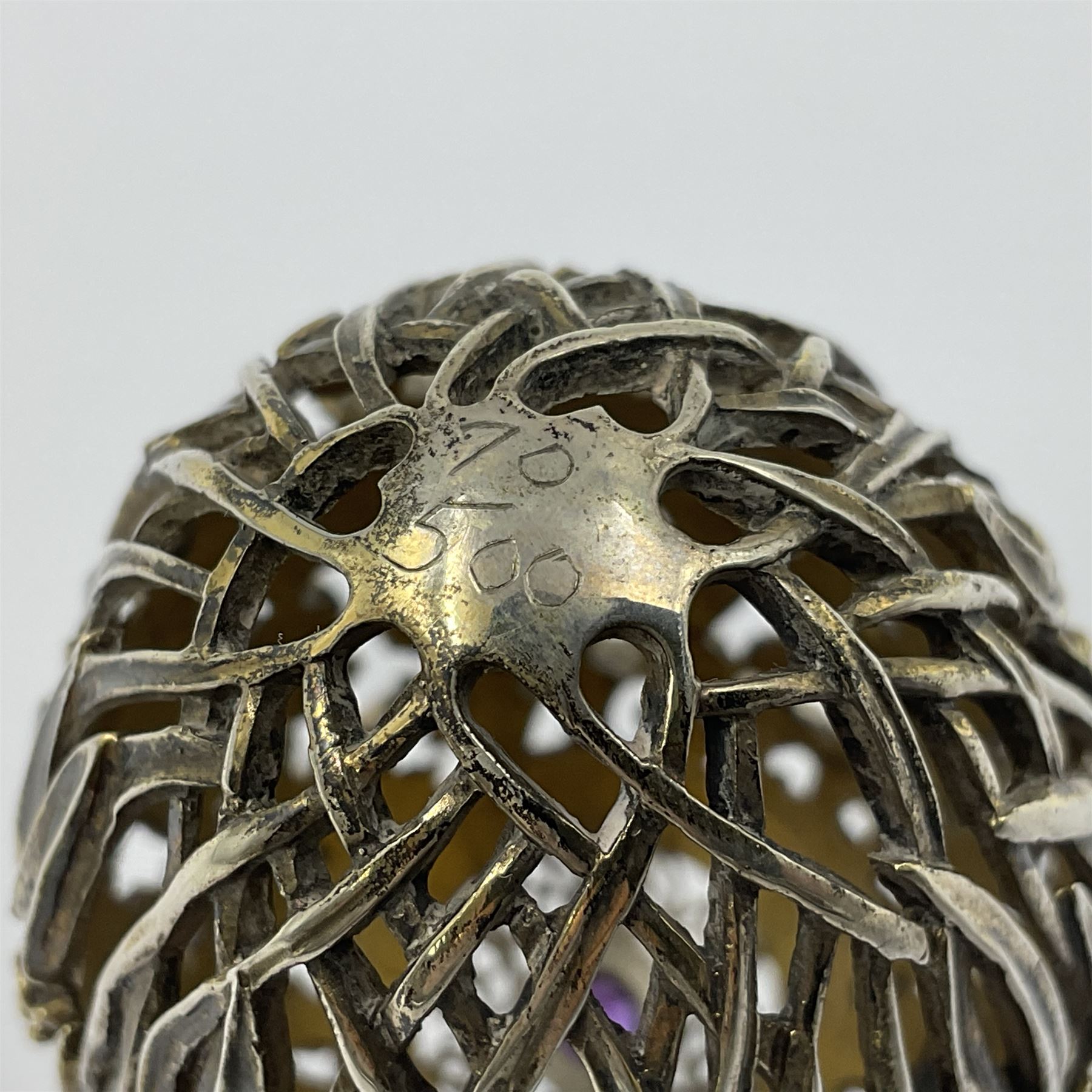 Modern silver limited edition Easter egg, no. 70/500, the gilt openwork body decorated with cascading bluebells and hinged cover with pierced circular panel set with a single faceted purple stone, opening to reveal a gilt interior, upon silver stand with three scrolling pad feet, each hallmarked St James House Company, London 1981, height including stand 8cm