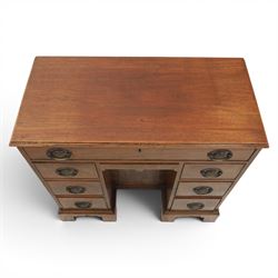 Early 20th century Georgian design figured walnut kneehole desk, rectangular moulded top over one long frieze drawer, kneehole recess with cupboard and drawer above, flanked by six short drawers with oval pressed brass handle plates, moulded plinth base on bracket feet