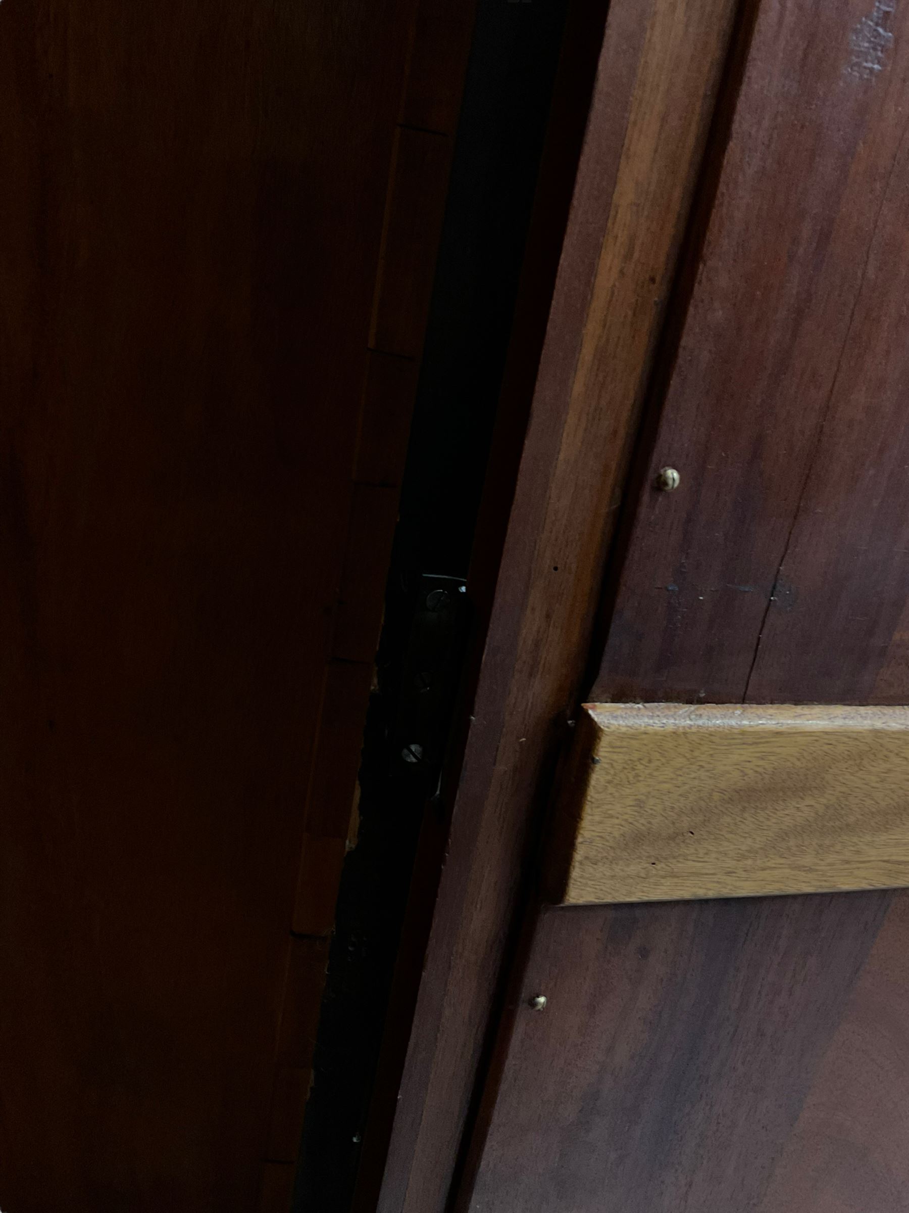 Late 19th century mahogany double wardrobe, projecting cornice over figured frieze, curved uprights enclosing two doors with bevelled mirrors, drawer to base, on splayed bracket feet