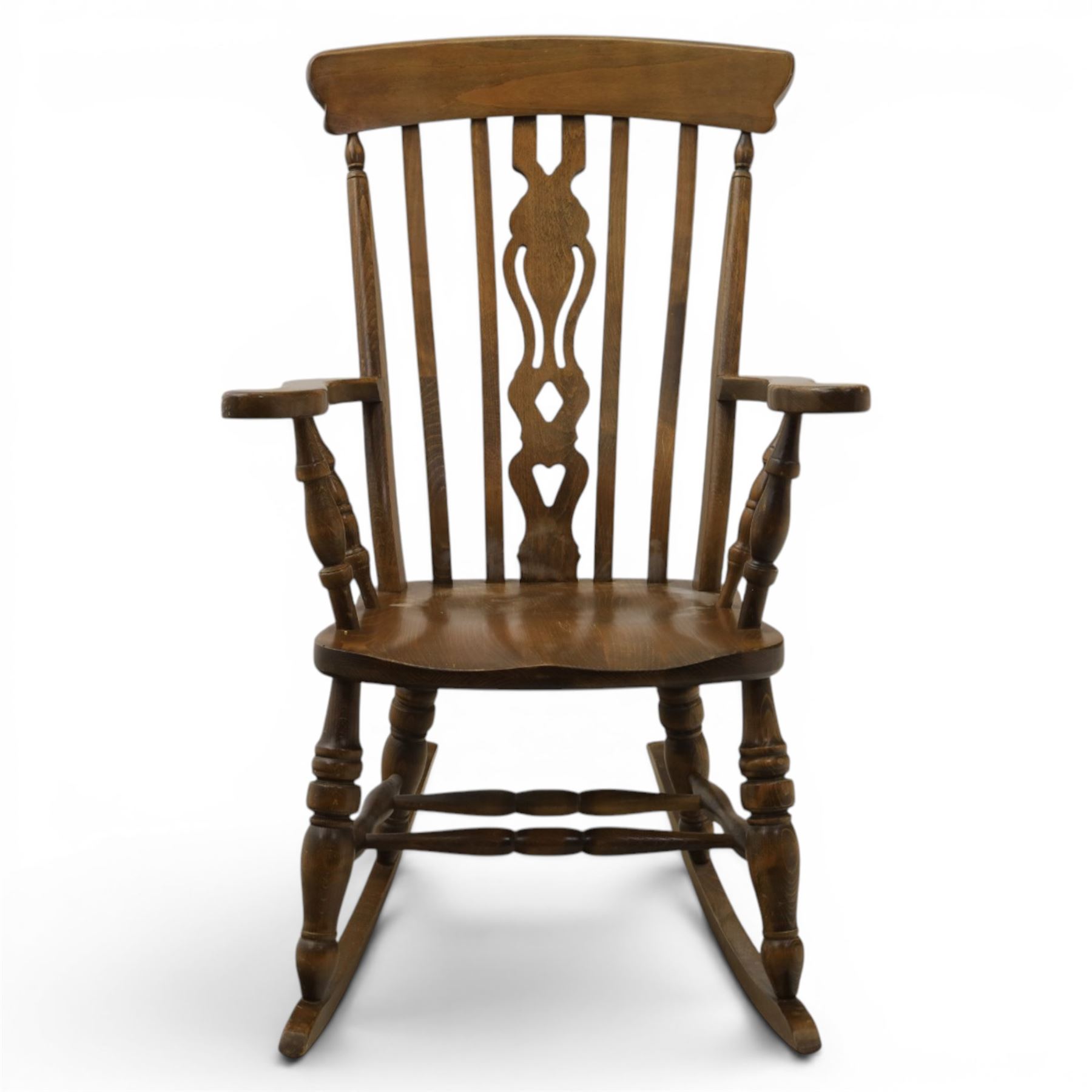 Farmhouse elm rocking chair, high back with 'Fleur De Lis' splat, shaped arms above turned supports, on rocker base 