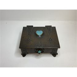 Arts and Crafts copper box, the lid decorated with stylised riveted hinges and inset with Ruskin type ceramic turquoise heart-shaped cabochon, the mount etched M.B 1913, and further cabochon roundel to each side panel, including one inset to the clasp acting as the knob to the locking mechanism, marked RS Douglas 1913 beneath, W16.5cm H7cm D15cm