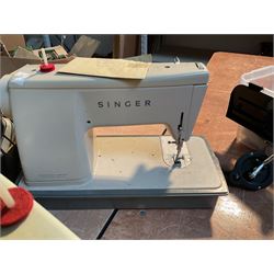 Two Singer sewing machines, model numbers 527 and 457, together with various Singer sewing machine parts, and a selection of sewing related accessories, to include threads, sewing needles, etc.