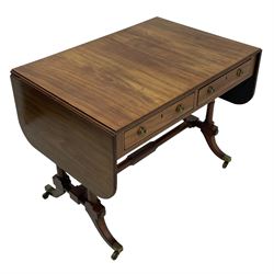 George III mahogany sofa table, rectangular drop-leaf top with reed moulded edge and rounded corners, fitted with two frieze drawers and two opposing false drawers, quadruple collar turned pillar supports on turned and block platforms, splayed and moulded supports with brass cups and castors 