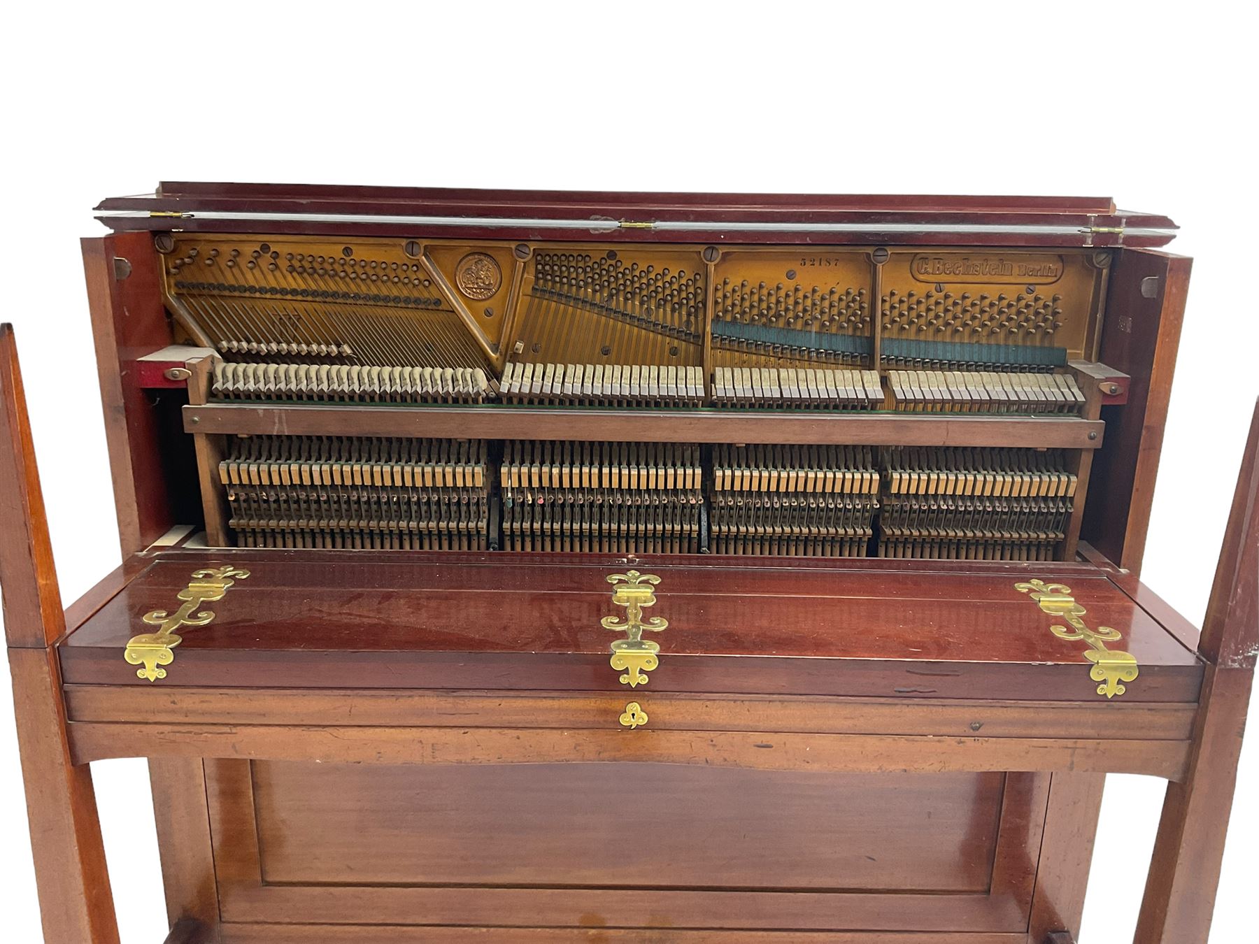 Carl Bechstein - late 19th century German overstrung upright piano, in a model 4 Arts and Crafts case designed by Walter Cave, with a lattice music desk and fretted silk backed front panel, brass hinged case lid and key fall with square tapered candle holders and circular sconces, iron frame, serial number 52187 (1899-1900), with an under damper action, 85 ebony and ivory keys, sustain and una corda pedals, original action, stringing, dampers, and action return straps, registered case number 328639, USA patent 24805.

This item has been registered for sale under Section 10 of the APHA Ivory Act