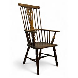 19th century provincial elm and beech Windsor armchair, shaped cresting rail over stick back with pierced and shaped splat, the dished seat on turned supports united by turned stretchers 