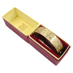 9ct gold hinged bangle with bright cut decoration by Henry Griffith & Sons Ltd, Birmingham