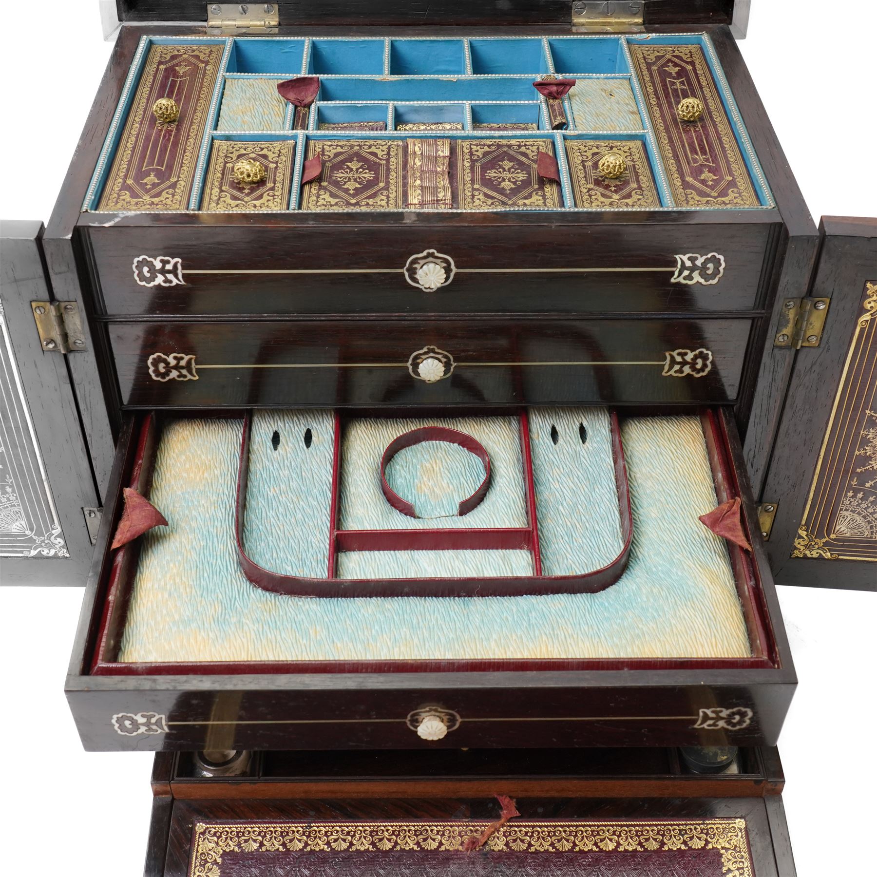 Early Victorian rosewood and mother of pearl inlaid sewing, jewellery, and writing casket  with hinged lid, the upper section fitted for sewing implements, above four drawers, the bottom drawer with writing slope and on compressed fluted feet H36cm x W34cm