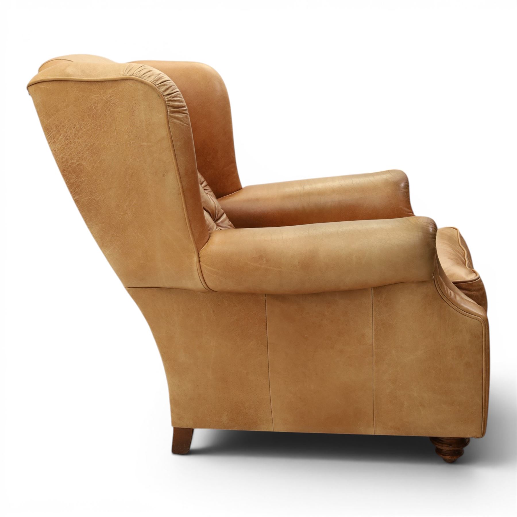 TETRAD for John Lewis - brown leather upholstered wingback armchair, button back with diamond tufted detail, loose seat cushion with piped edge, scroll arms and padded side wings, on short supports