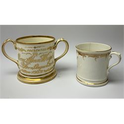 A 19th century Staffordshire documentary loving cup, inscribed in gilt to one side 'Presented to Mary Ann Wright Born August 29th 1862', and hand painted with flowers verso, H10cm, together with a smaller single handled example inscribed in gilt 'A Present from Lytham', H8.5cm. (2).