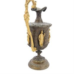 Pair of bronzed and gilt ewers in the Neo-Classical taste, each of typical form with figural detailed and mounted scroll handle surmounted by a winged figure, the bodies cast with scrolling strapwork, flower heads and acanthus leaves, and further detailed with applied gilt classical figures to oval recesses, upon a knopped stem and spreading circular foot with conforming cast detail, H28cm