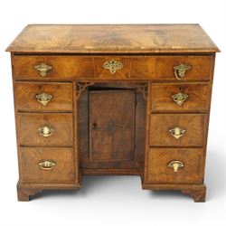 George III figured walnut kneehole desk, the rectangular top with feather and cross-banding with moulded edge, fitted with single frieze drawer over pierced spandrels and recessed cupboard, flanked by six graduating drawers, raised on bracket feet
Provenance: Kirkham Hall