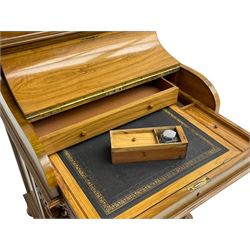 Fine and unusual 19th century olivewood piano top davenport, raised shaped back carved with olive branches and olives, the top hinges to reveal lidded and correspondence compartments, the piano lid enclosing sliding top with hinged and adjustable writing surface with leather inset, right-hand panelled door enclosing four drawers, olive branch and scroll carved cabriole front supports on moulded and shaped platform, turned cup feet with recessed castors 