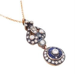 Gold and silver sapphire and diamond pendant, single round brilliant cut diamond, surrounded by calibre cut sapphires and round brilliant cut diamonds, suspending from a fancy pendant set with further diamonds, on a rose gold plated silver chain necklace, total diamond weight approx 0.60 carat