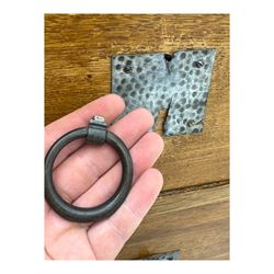 Early 20th century Arts and Crafts oak dressing chest, the arched mirror flanked by floral marquetry inlaid uprights above a shelf and drawer, over three long drawers with square hammered metal plates and circular pulls, on slender supports with castors