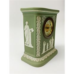 An early 20th century Wedgwood sage green jasper timepiece, decorated with classical figures and further detailed with foliate bands, with impressed marks verso, H15.5cm, together with a Paxton buff ground jasperware jug, decorated with a band of figures, H17cm. (2). 