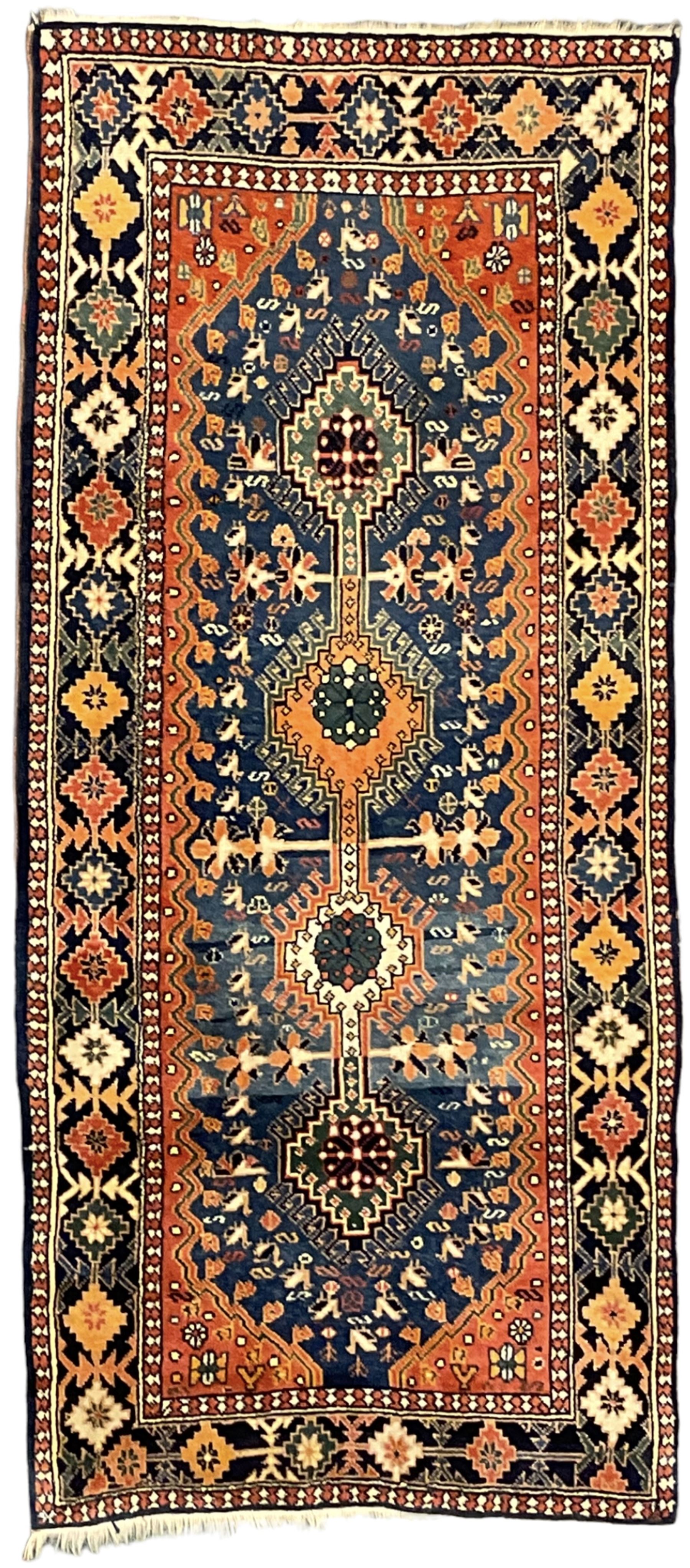 Persian blue ground rug, field decorated with four pole medallions with surrounding repeating bird motifs, coral spandrels with flowerheads, guarded border decorated with repeating geometric lozenges
