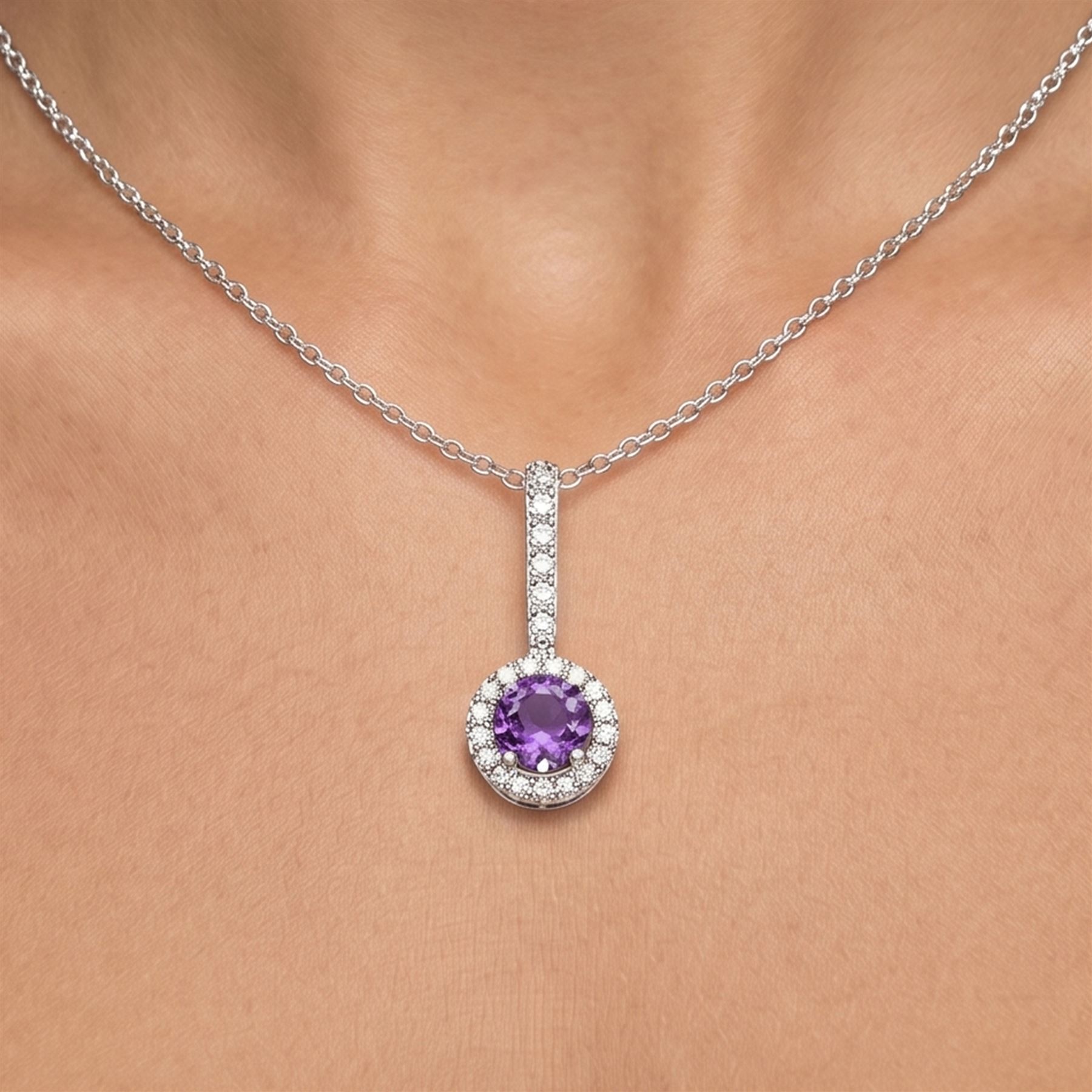 Early 20th century white gold silver amethyst and diamond pendant, round cut amethyst, surrounded by seventeen old cut diamonds, suspending from a five stone diamond set bail, to a silver chain necklace, total diamond weight approx 0.40 carat