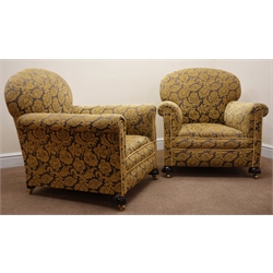  Pair Victorian upholstered armchairs, upholstered in floral patterned gold and gun metal coloured fabric, turned supports on brass castors, W86cm   