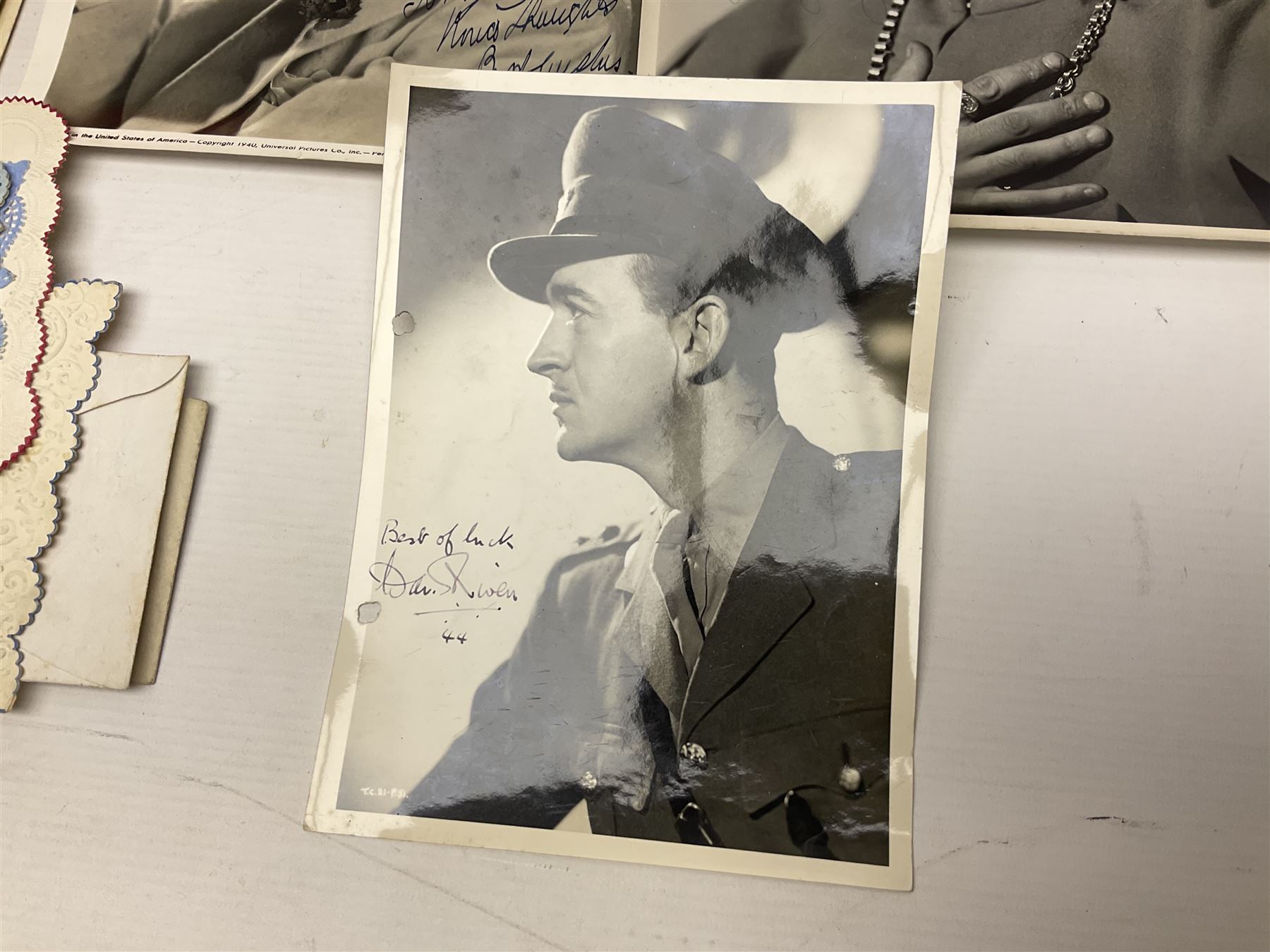 Early 20th century ephemera, to include signed photographs of Charles Boyer and Walter Pidgeon etc, a printed letter from Winston Churchill, two albums and a quantity of transfer books of Players and similar cigarette cards, including Boy Scout and Girl Guide Patrol Signs and Emblems and RAF Badges, a collection of greetings cards and postcards, a photograph album containing black and white photographs of Caius College Cambridge and guides and pamphlets on travelling Switzerland and the UK