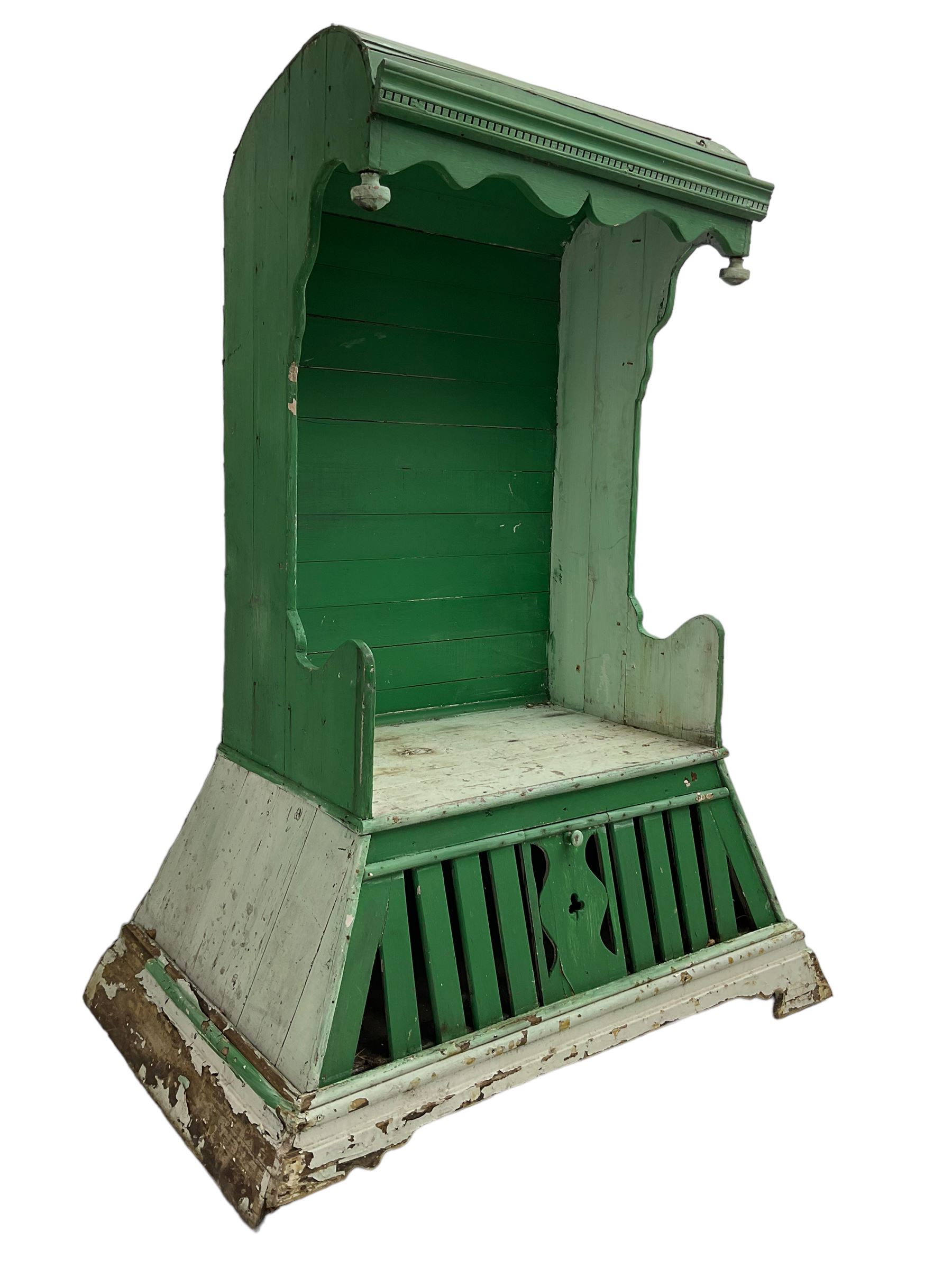 19th century painted pine hen coop settle, overhanging arched canape with dentil moulding and shaped edge, the panelled seat over a triangular platform base with removable hen-coop door, in green and white finish
