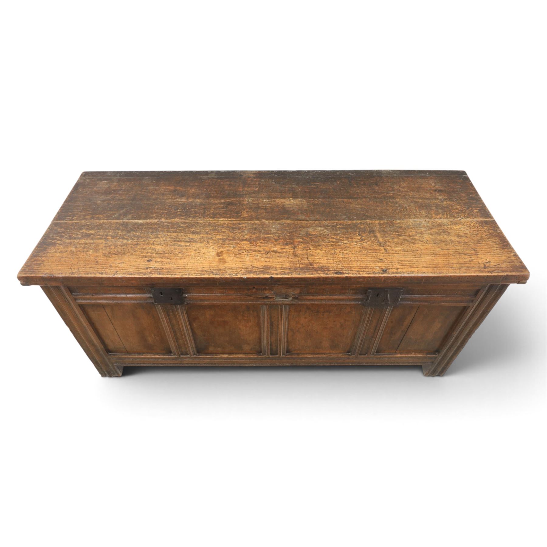 Large 17th century oak coffer, plank top with moulded edge, four panel front with channel moulded uprights, retaining original wrought iron strap hinges and central lock plate, panelled ends, raised on stile supports