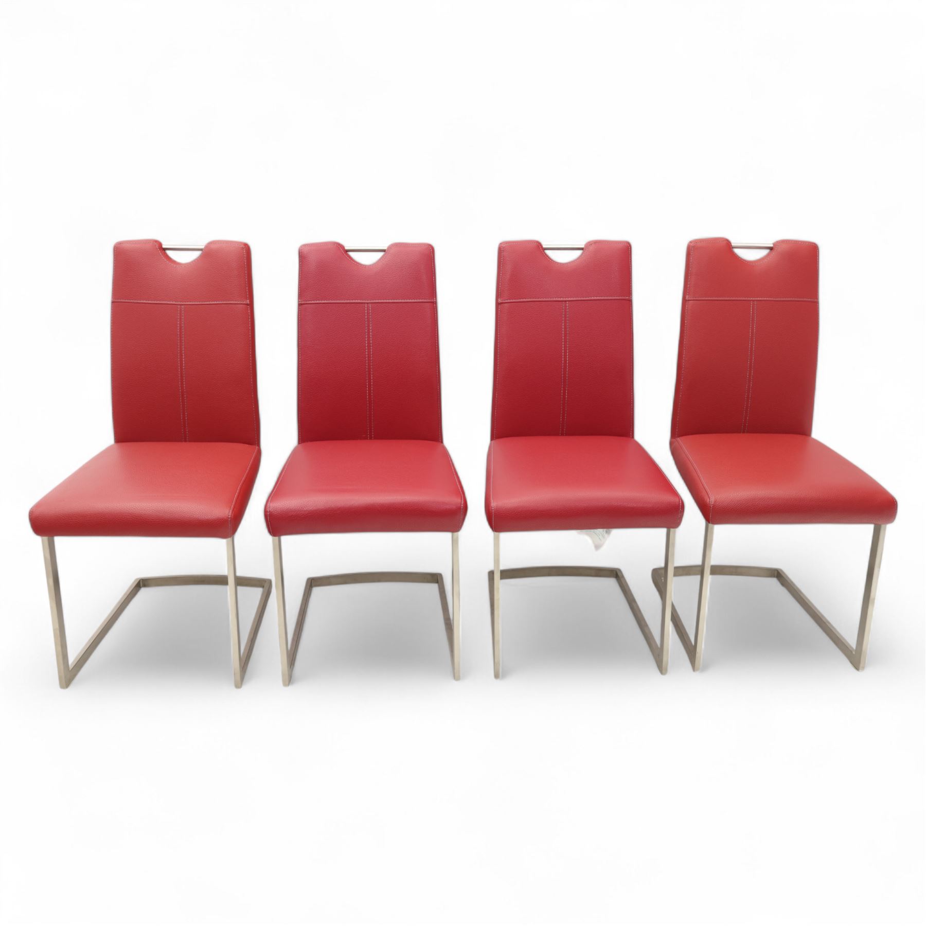 Set of seven contemporary style dining chairs, each with a high padded back and seat upholstered in faux leather on brushed steel sled bases  