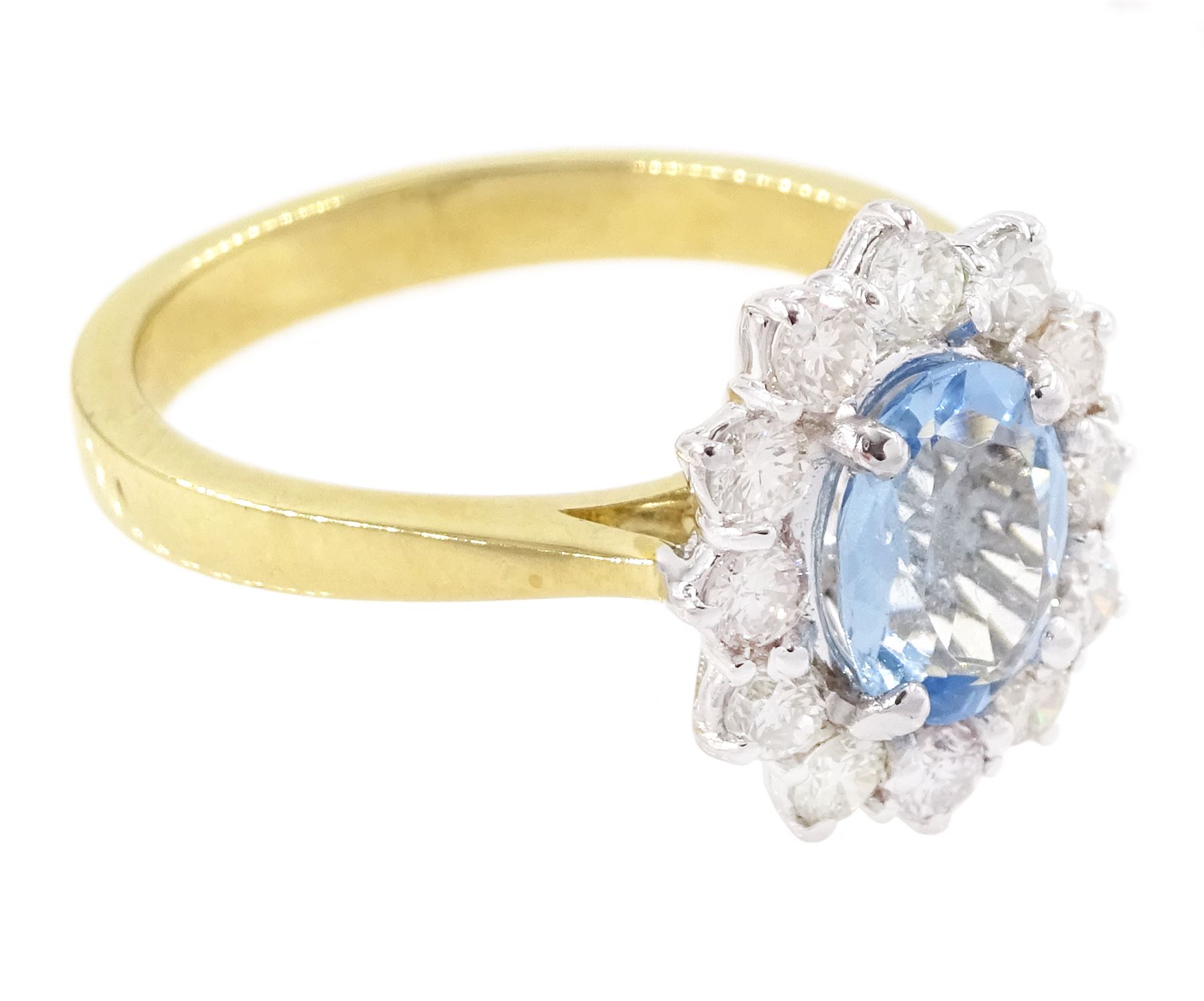 18ct gold aquamarine and diamond cluster ring, oval cut aquamarine of approx 0.80 carat, with round brilliant cut diamond surround, London 2022, total diamond weight approx 0.55 carat
