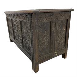 18th century oak coffer, the triple panelled hinged lid with moulded frame over triple panelled front, foliate arcade carved frieze rail, two lozenge carved panels with foliage corners, central arch carved panel with scrolling foliate and pillars, foliate carved rails and double panelled sides decorated with pointed arch and roundel carvings, on stile supports