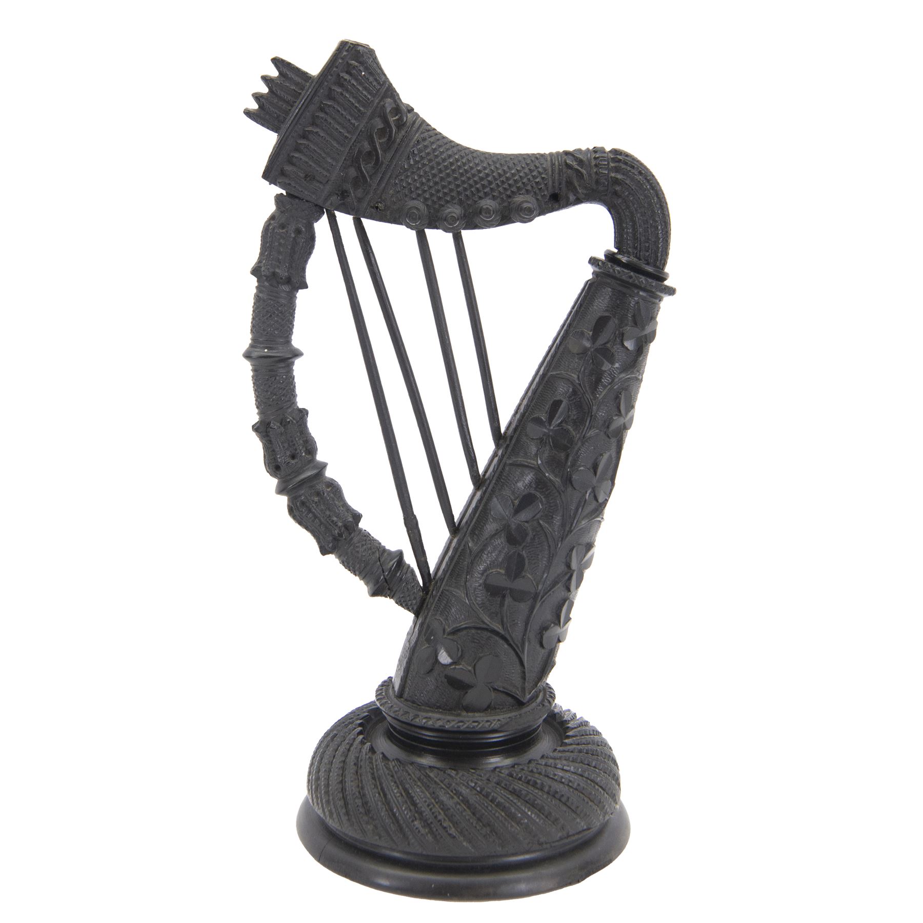 19th century Irish carved bog oak model of a harp, detailed with fluting, diamond cuts and shamrocks, upon a turned circular base, H29cm
