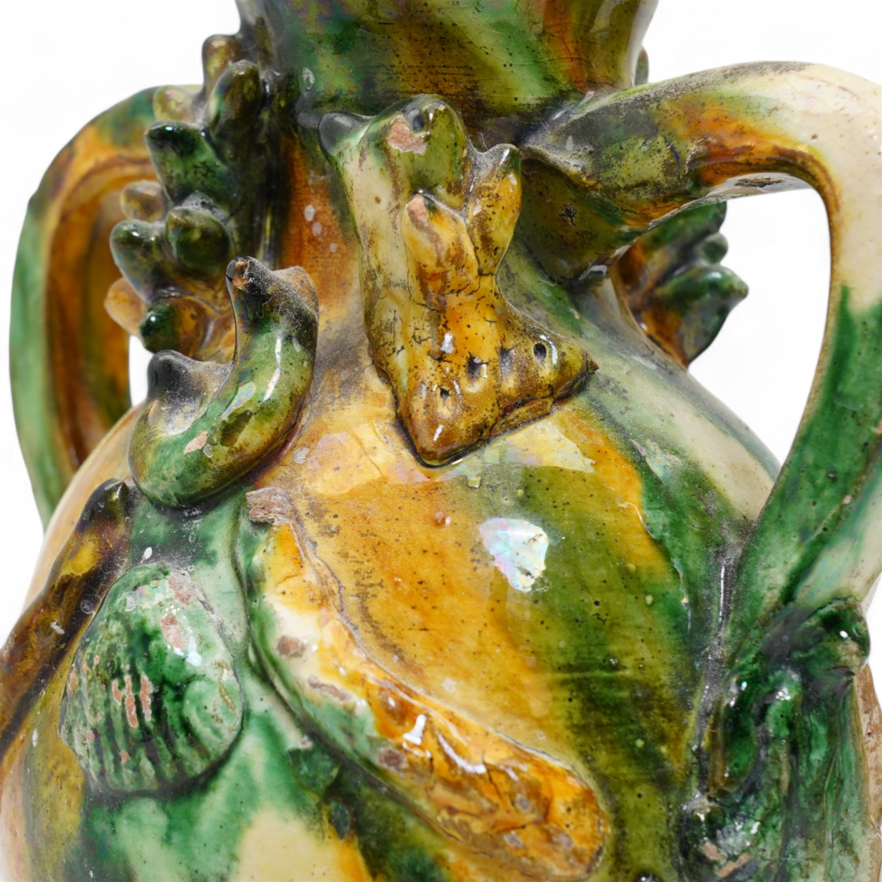 Two early 20th century Italian glazed terracotta wine flasks, one of twin handled form, applied with shells and insects, the other formed as a male figure, H24cm (2)