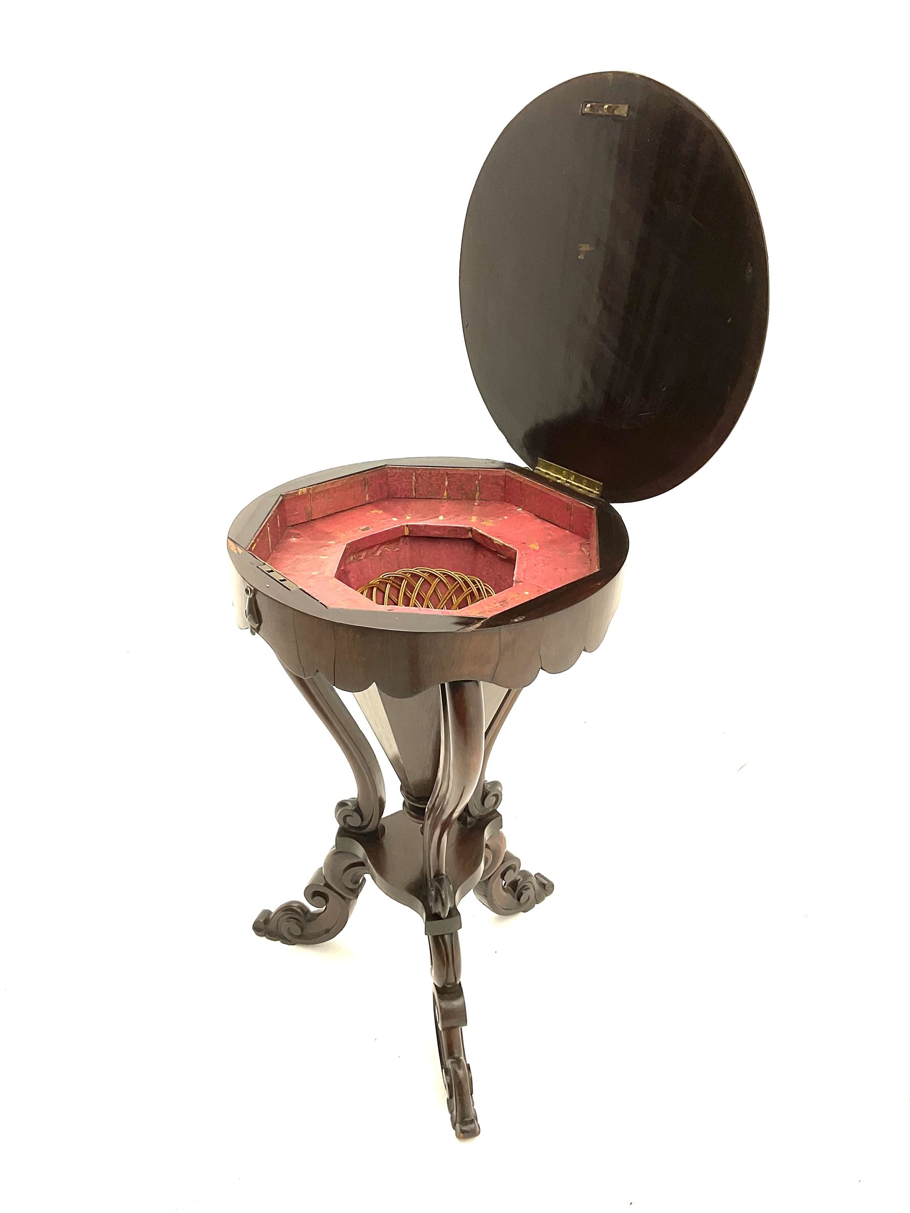 Victorian rosewood work table, circular hinged lid enclosing trumpet shaped body with fitted interior, scroll carved serpentine supports, on tripod base