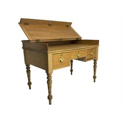 Early 20th century light oak kneehole desk, rectangular hinged top, fitted with frieze drawer flanked by two deep drawers, raised on ring turned supports