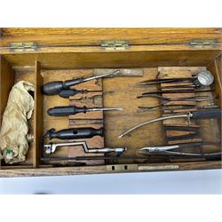 Naval doctor's surgical instruments, contained in a converted brass bound oak pistol box, the hinged lid opening to reveal two removable fitted trays, containing 19th century and later saws, scalpels, tweezers etc