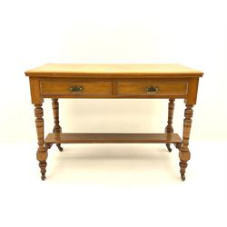 Edwardian satin walnut side table, fitted with two drawers, raised on turned supports and joined by under tier stretcher and castors 