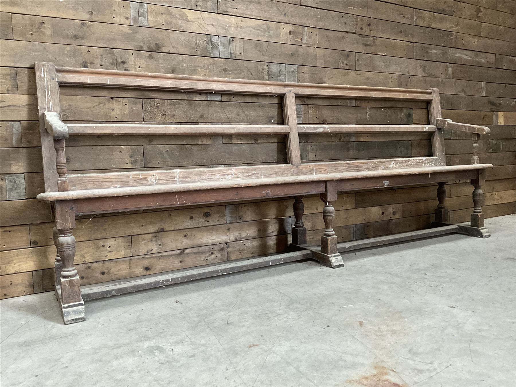 Victorian pitch pine bench pew, turned arms and legs, rail back with plank seat, 249cm